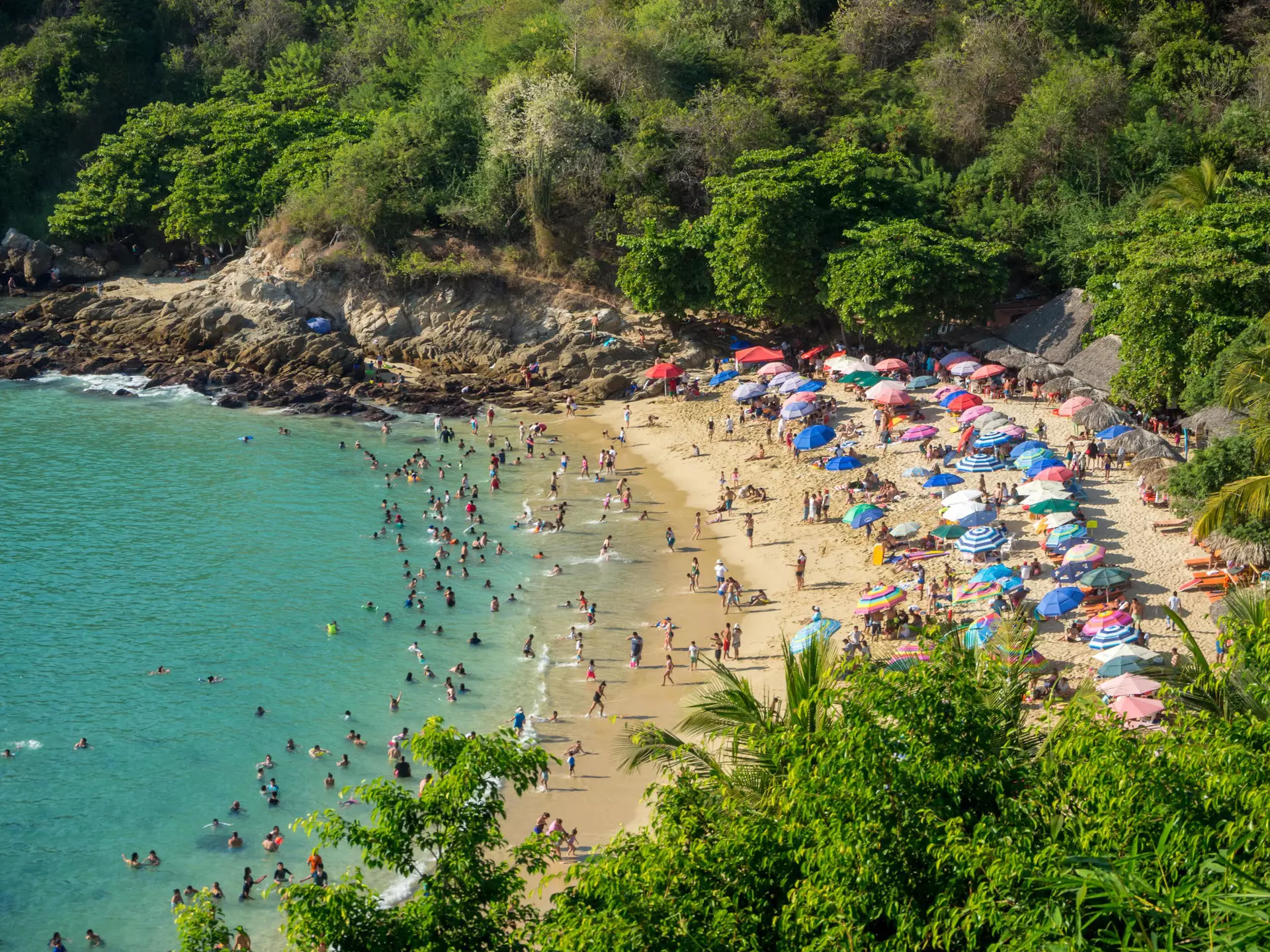January 2018: The crowded beach of Playa Carrizalillo in Puerto Escondido.