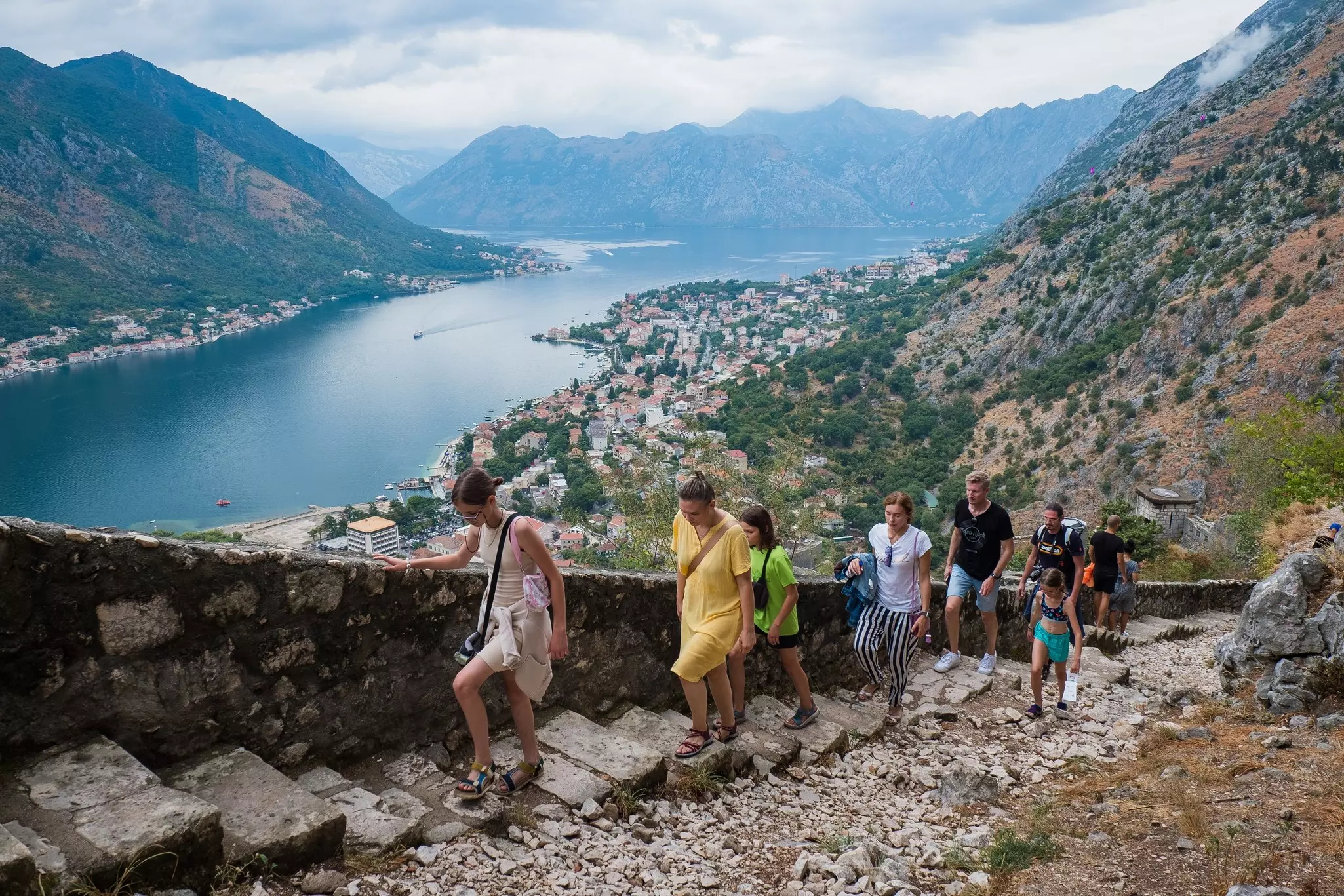 People walking up from stone staircase leading to St. John's Castle in Kotor on Montenegro’s Adriatic coast.
