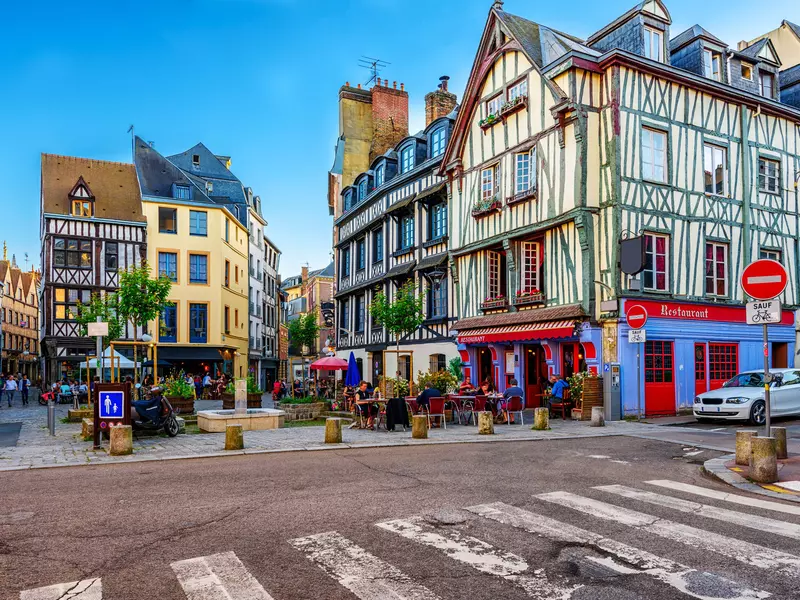 A street with half-timbered buildings, cobbled streets and restaurants with outdoor terraces