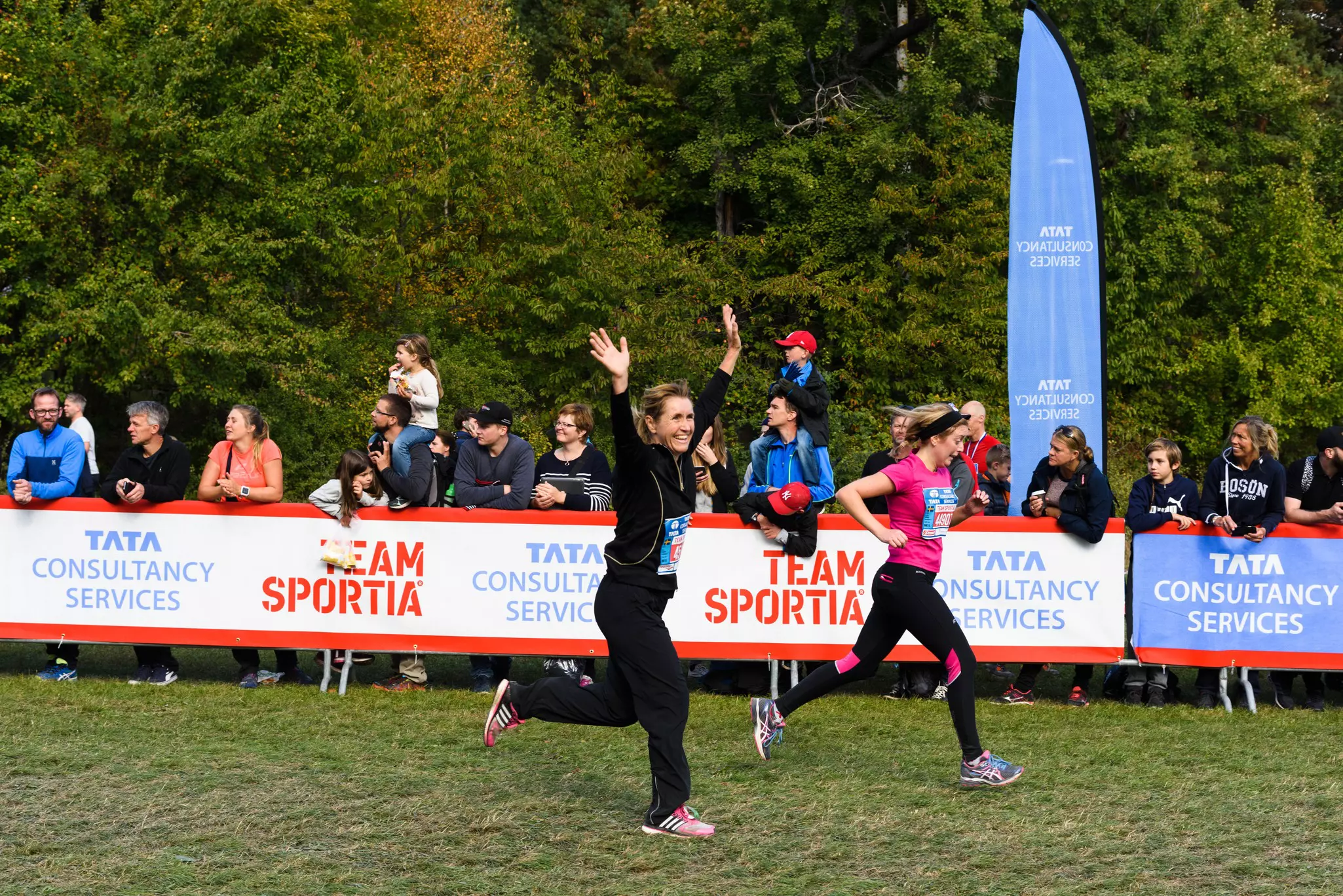 Woman raising her hands as she crosses the finish line in the Lidingöloppet race, Sweden