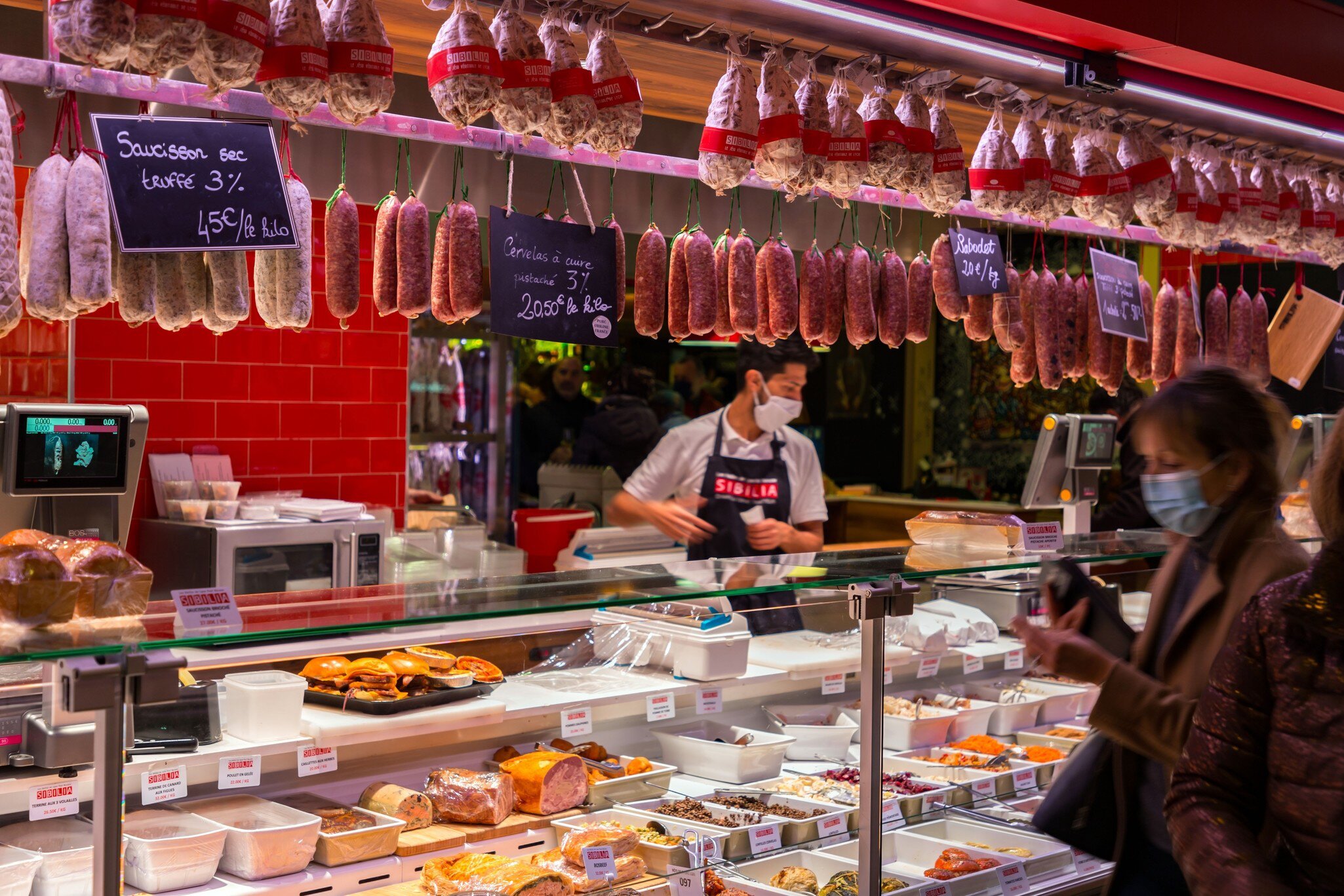 Interior photo of gourmet food sold at Les Halles de Lyon Paul Bocuse, built in 1971 in the 3rd arrondissement of Lyon, Auvergne-Rhone-Alpes, France.