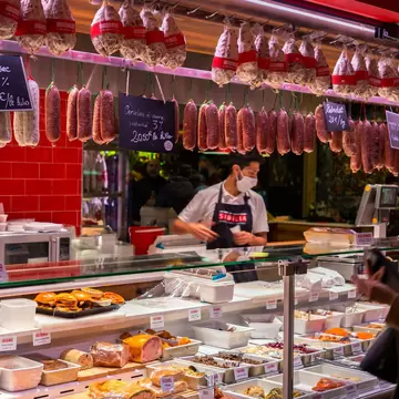 Interior photo of gourmet food sold at Les Halles de Lyon Paul Bocuse, built in 1971 in the 3rd arrondissement of Lyon, Auvergne-Rhone-Alpes, France.