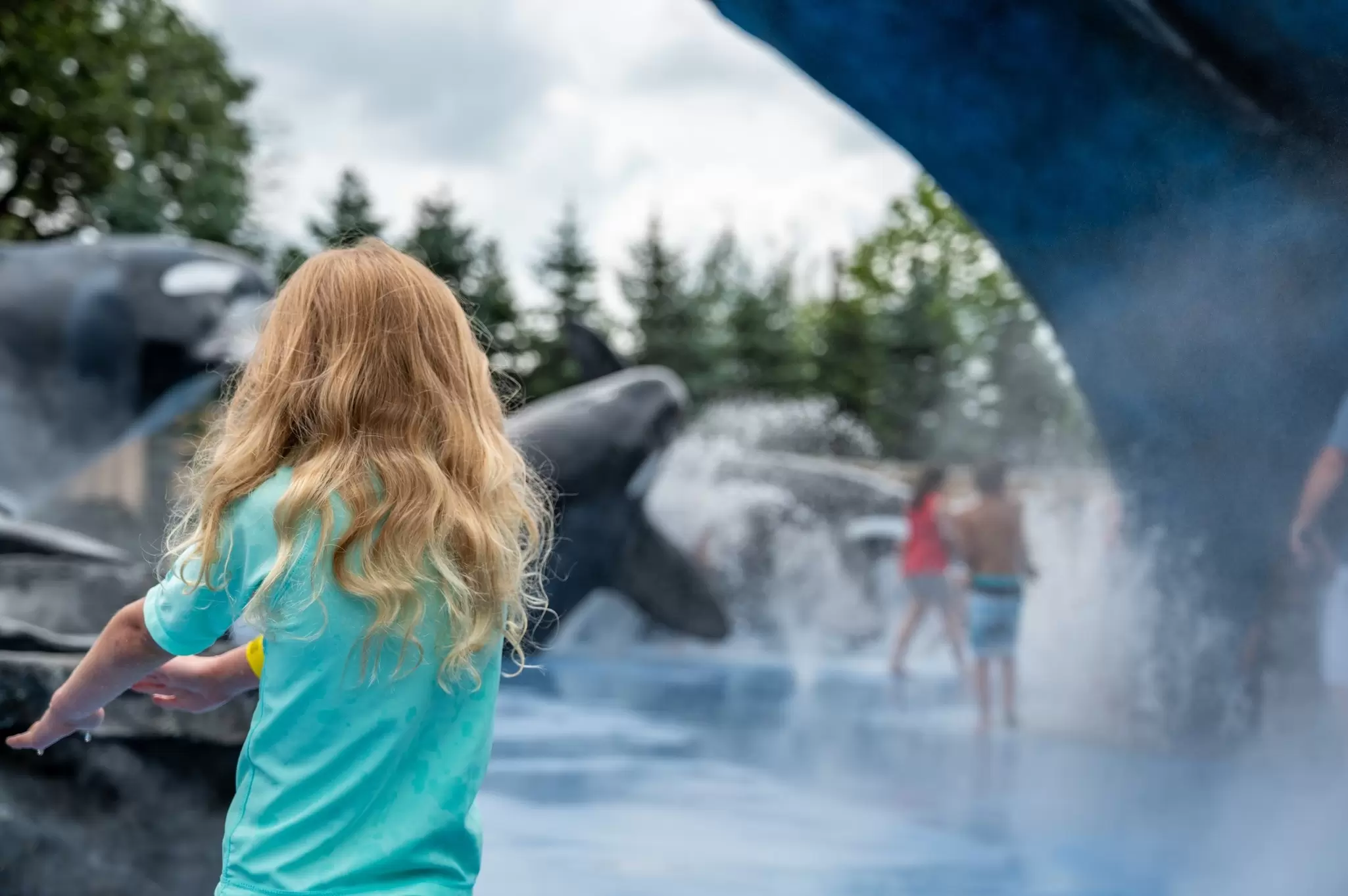 A child plays in a splash park at Henry Dorly Zoo
