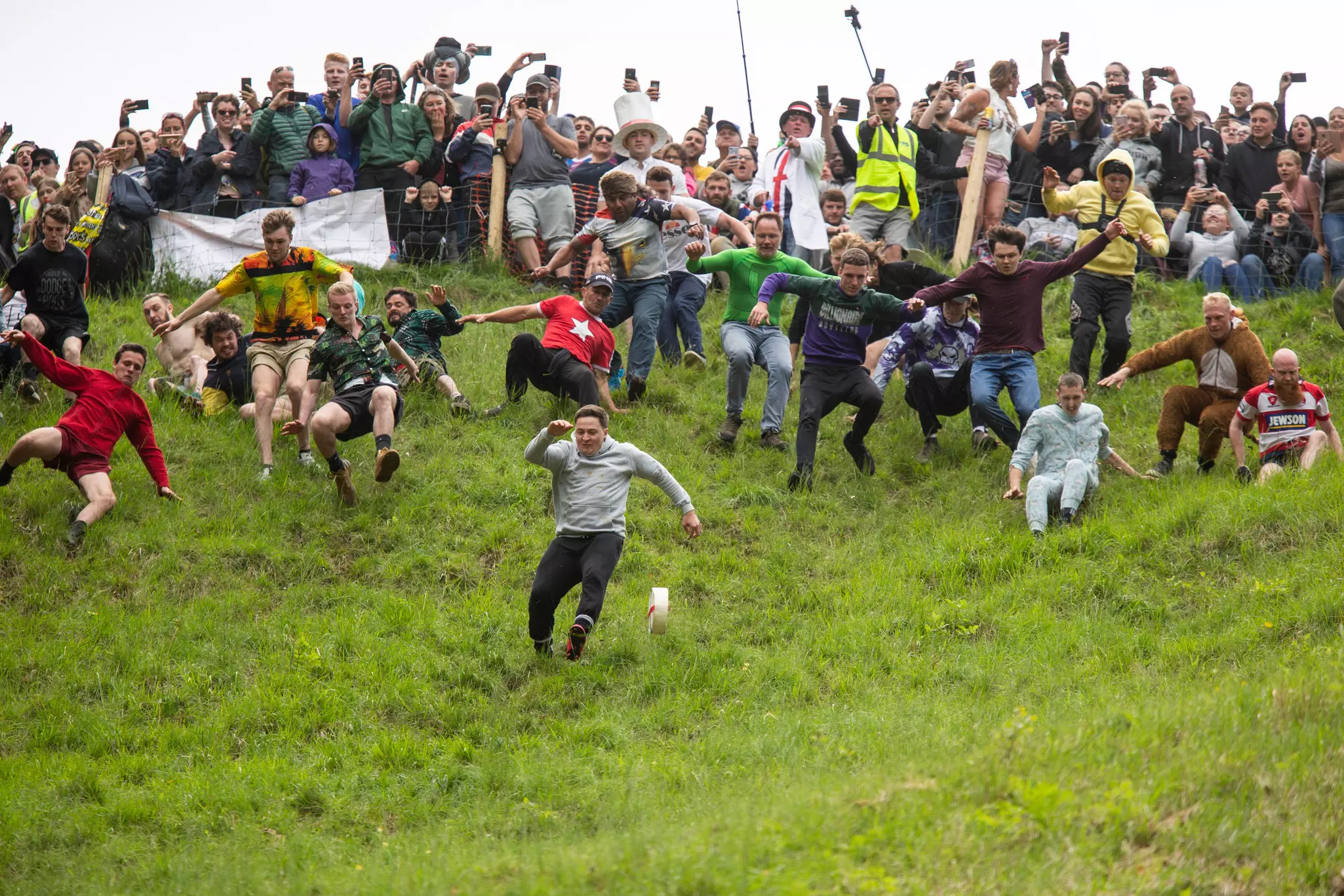 Eventual winner (front left) Max McDougall chases the cheese during the annual Spring bank holiday cheese-rolling event at Cooper's Hill near Gloucester.
