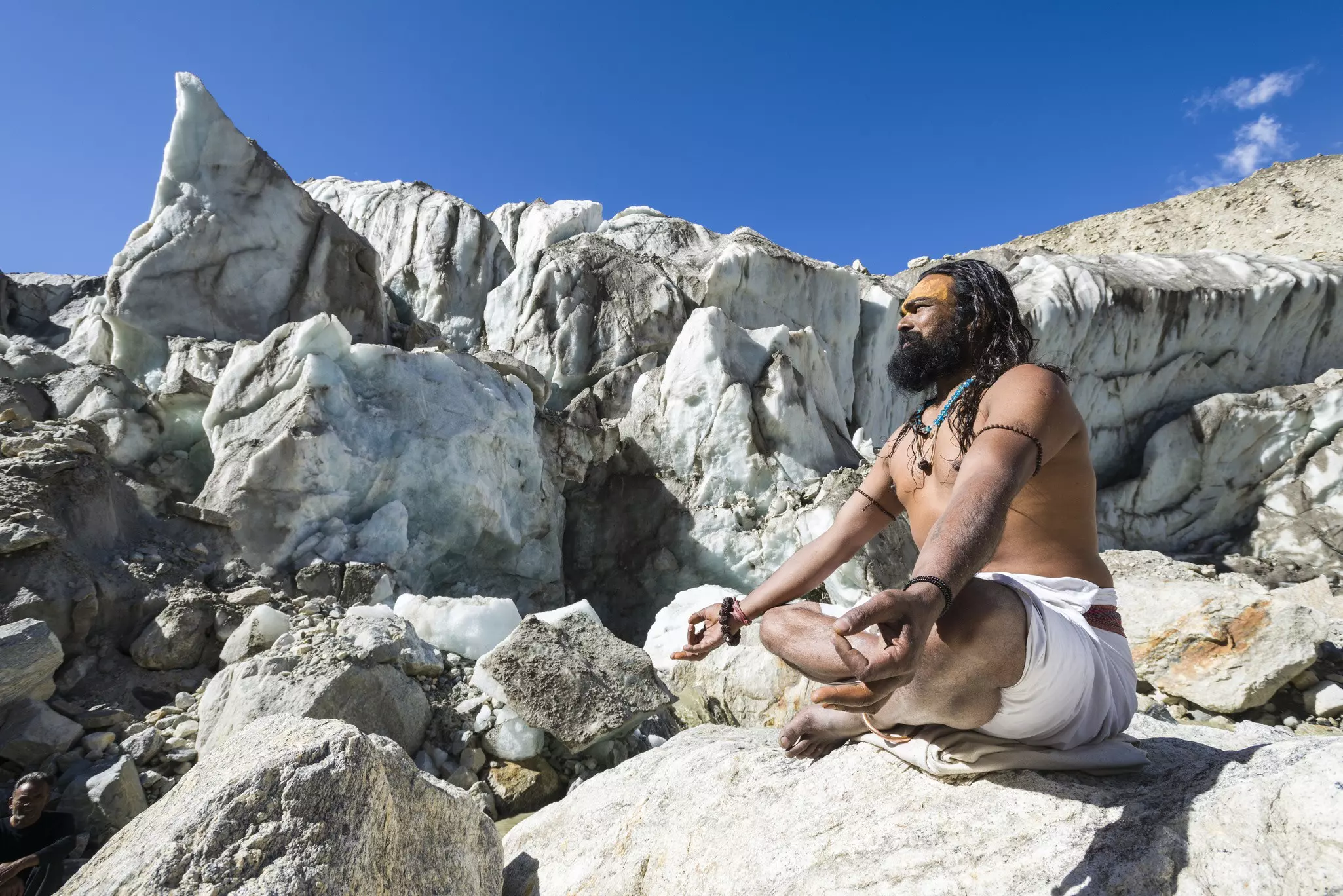 A sadhu (holy man) meditating on a rock at Gaumukh, the source of the holy River Ganges © Frank Bienewald / LightRocket via Getty Images