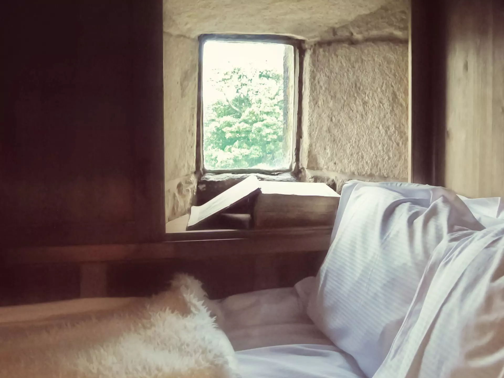 Ponden Hall is a historic house near Haworth, West Yorkshire, England, with many connections with the literary Bronte sisters who lived in the 19th century..This window is believed to be the model for the window in Emily Bronte's novel "Wuthering Heights" where the heroine Cathy's ghost appears and struggles to get in. A replica boxed bed has been built around it to match the one described in the novel.