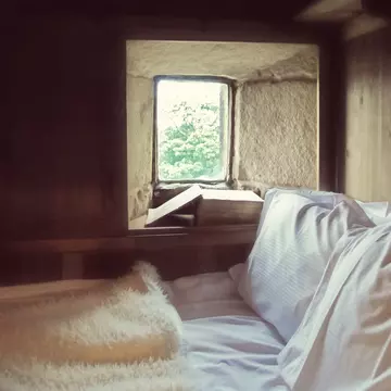 Ponden Hall is a historic house near Haworth, West Yorkshire, England, with many connections with the literary Bronte sisters who lived in the 19th century..This window is believed to be the model for the window in Emily Bronte's novel "Wuthering Heights" where the heroine Cathy's ghost appears and struggles to get in. A replica boxed bed has been built around it to match the one described in the novel.
