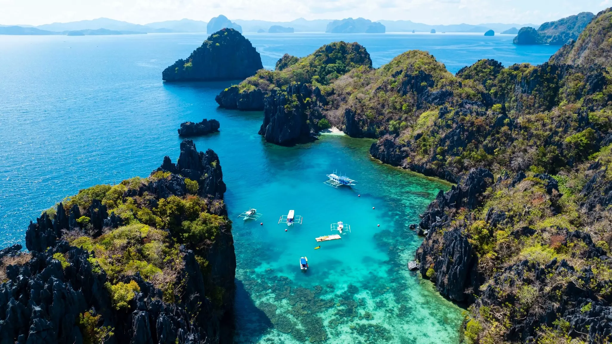 View of limestone rock formations in a blue-green ocean