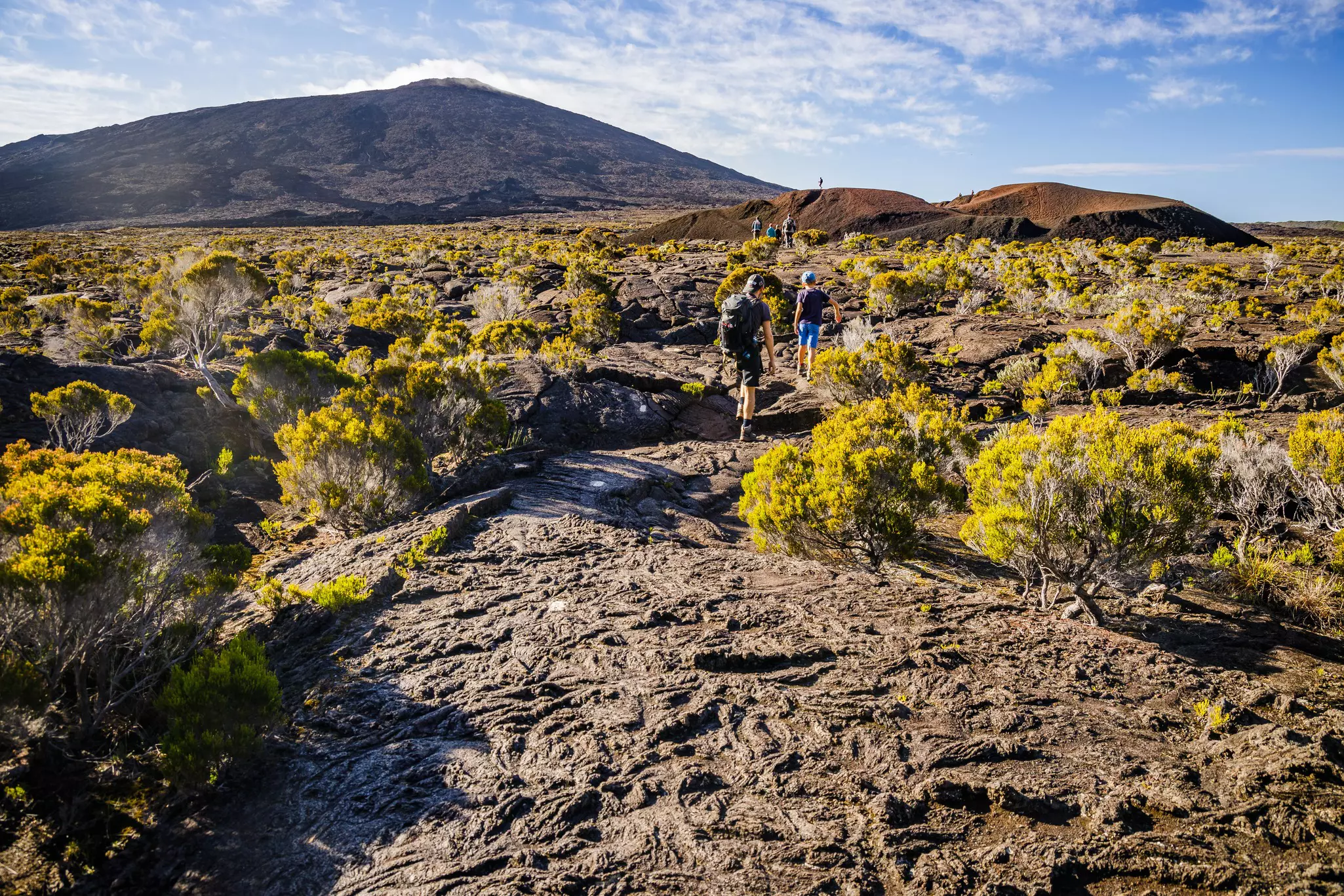 Hikers walking to the summit of the Piton de la Fournaise volcano