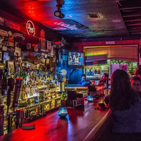 A bar scene with bottles and people