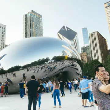 Crowds pose around the famous Cloudgate sculpture in Millennium Park