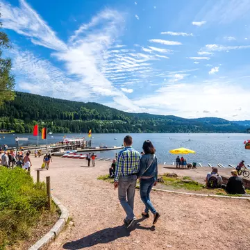 A pleasure boat navigating a waterway in Amsterdam, a key Killing Eve season two location; the canal is lined with colourful medieval houses and boats.