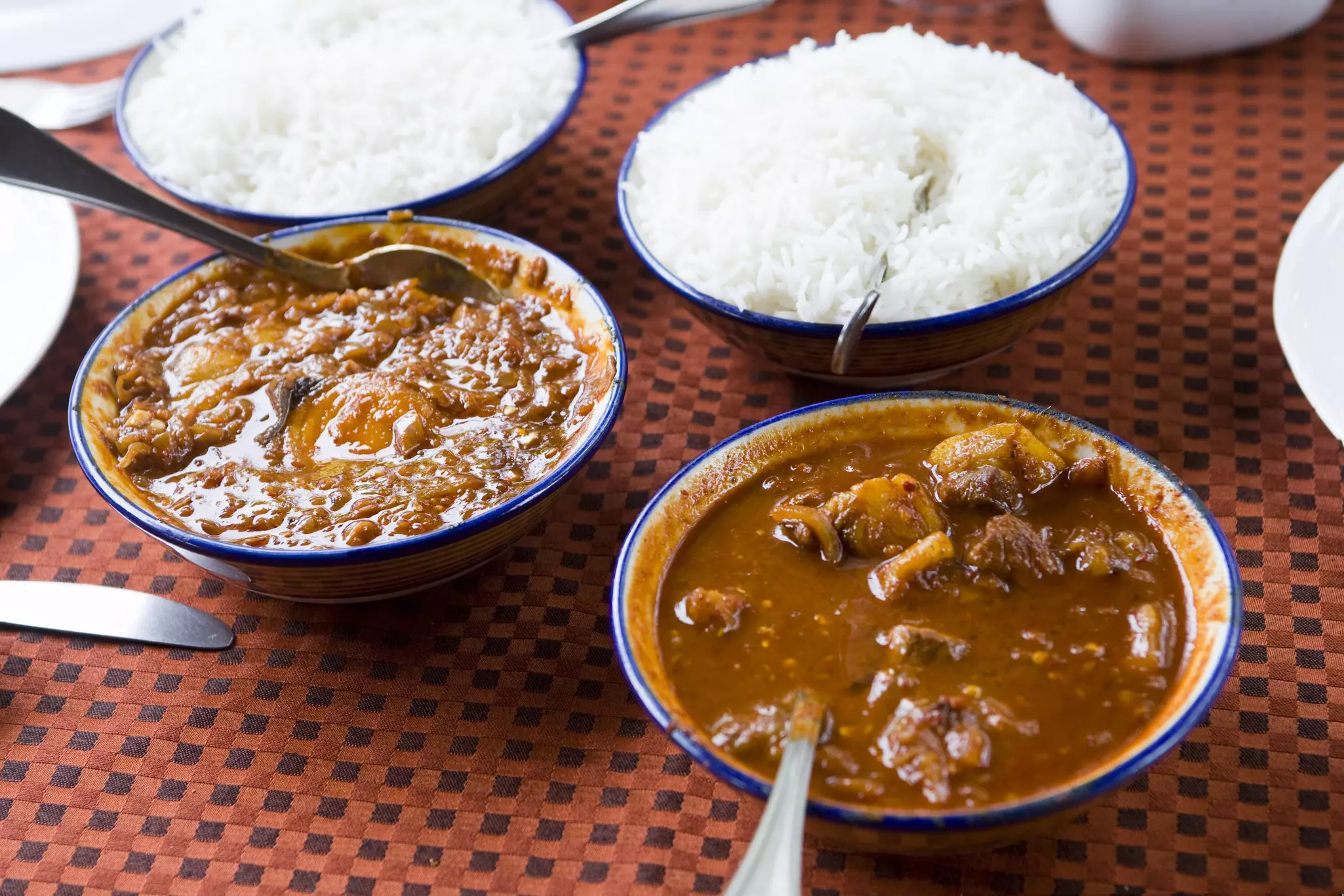 Curry dishes and rice at a restaurant in Betalbatim, Goa, India.
