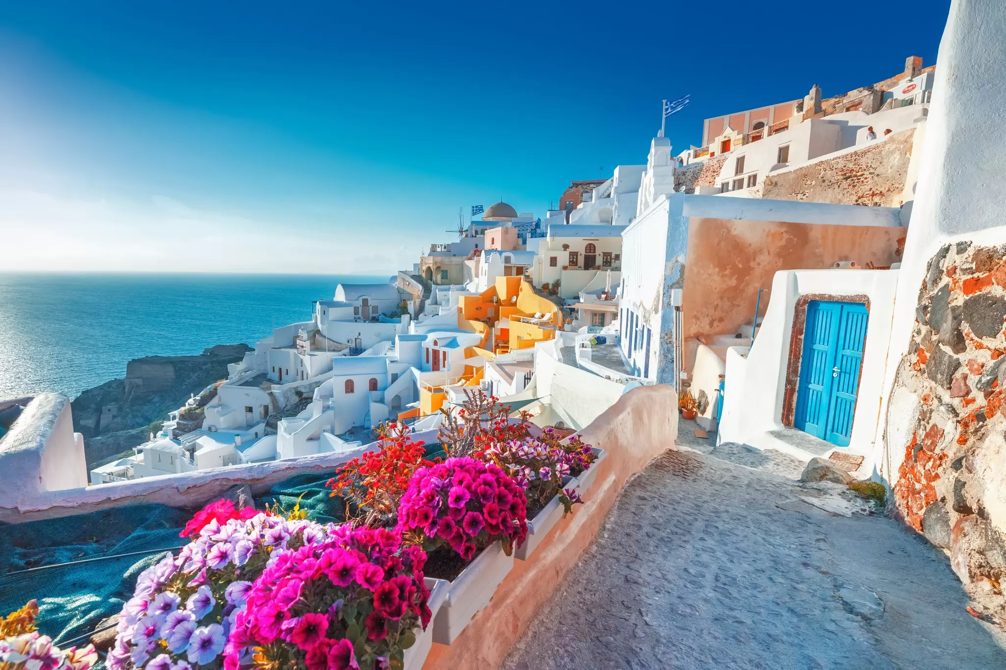 A path winding past white Cycladic houses in Oia village, Santorini, Greece