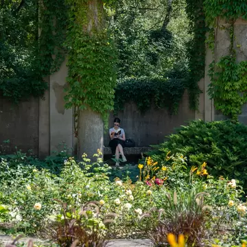 A woman sitting and reading in Tiergarten. Berlin, Germany.