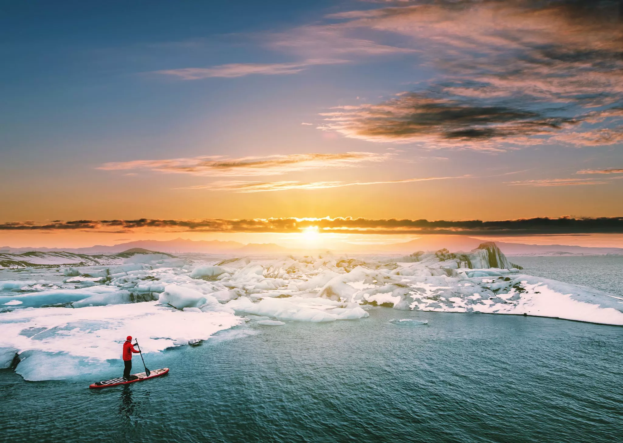 Exploring glacial lagoons by stand-up paddleboard is a surreal experience. SasinParaksa / Getty Images