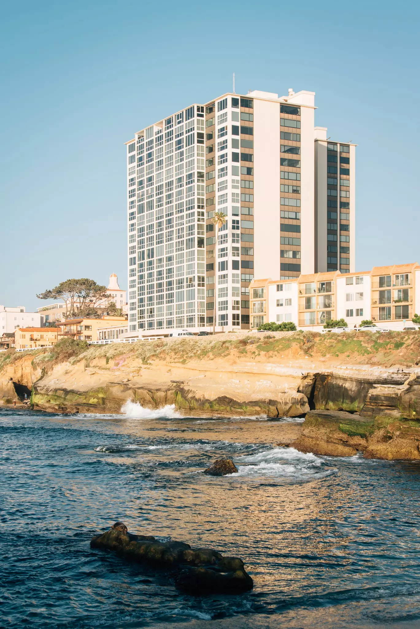 Buildings along a rocky coast in California.