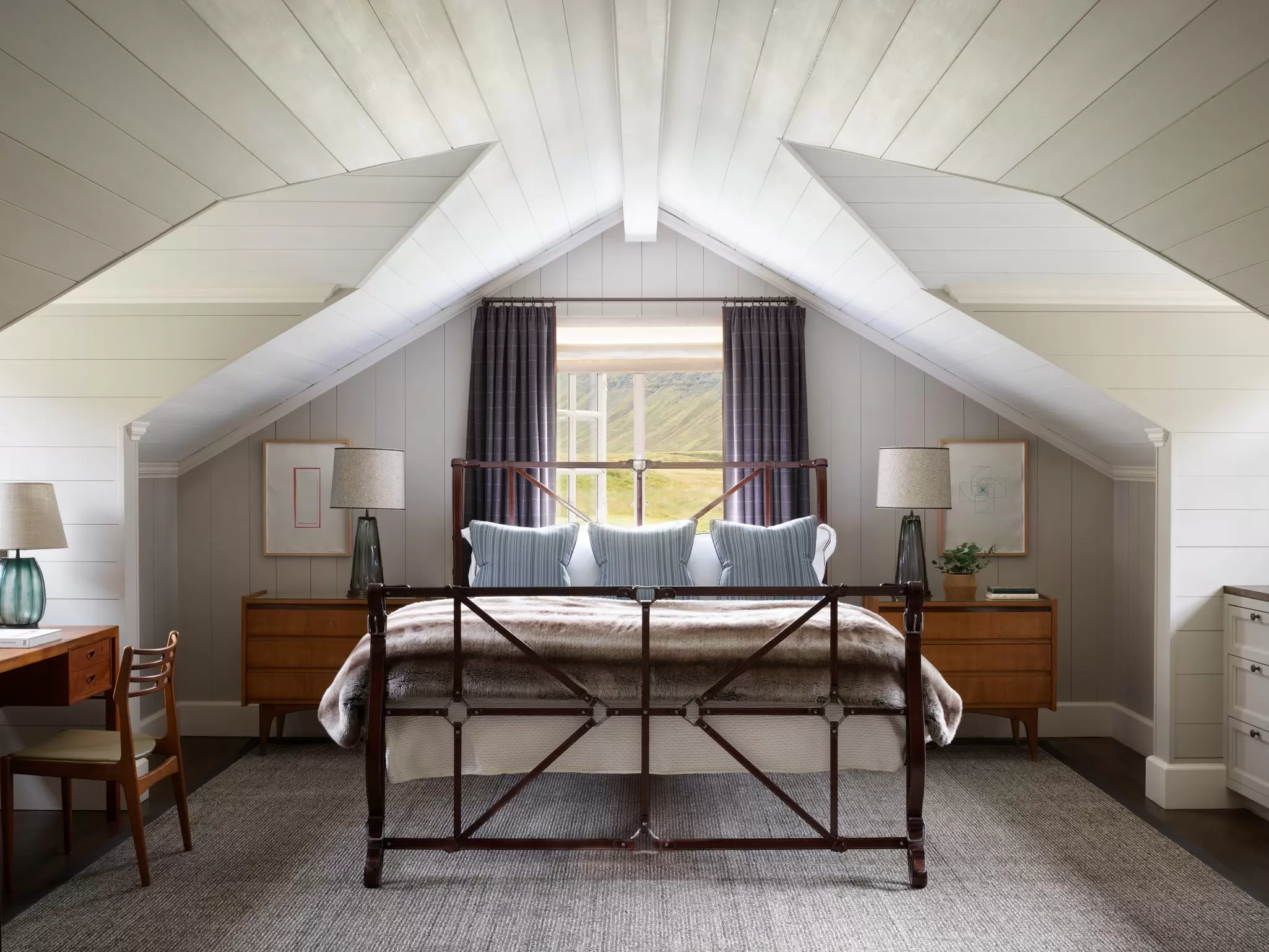A stylish symmetrical bedroom in a boutique hotel; Eleven Deplar Farm, Iceland