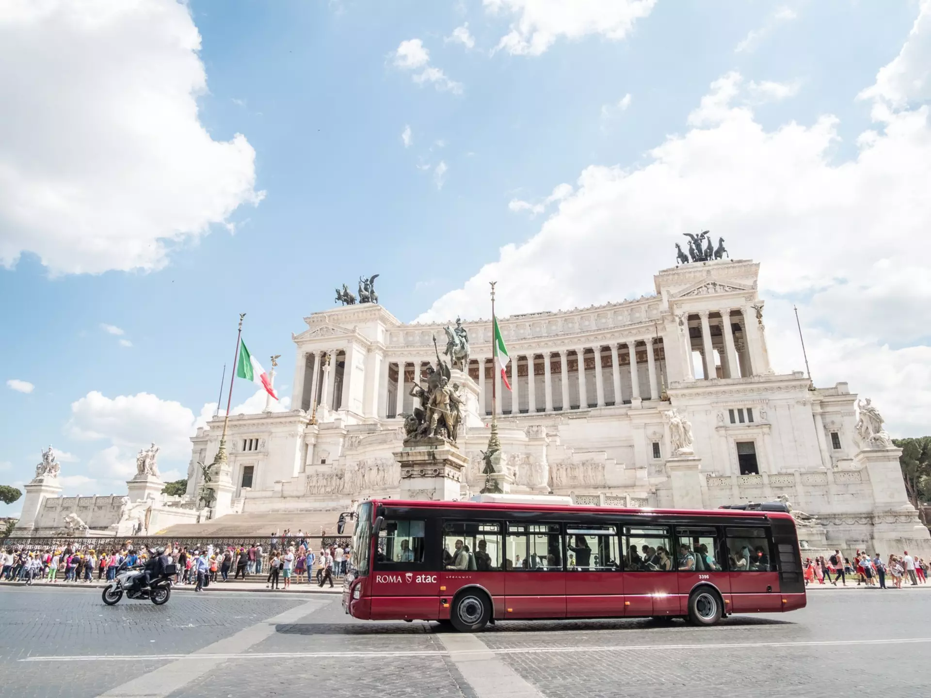 A bus passes Rome's Vittoriano. moomusician/Getty Images