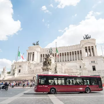 A bus passes Rome's Vittoriano. moomusician/Getty Images