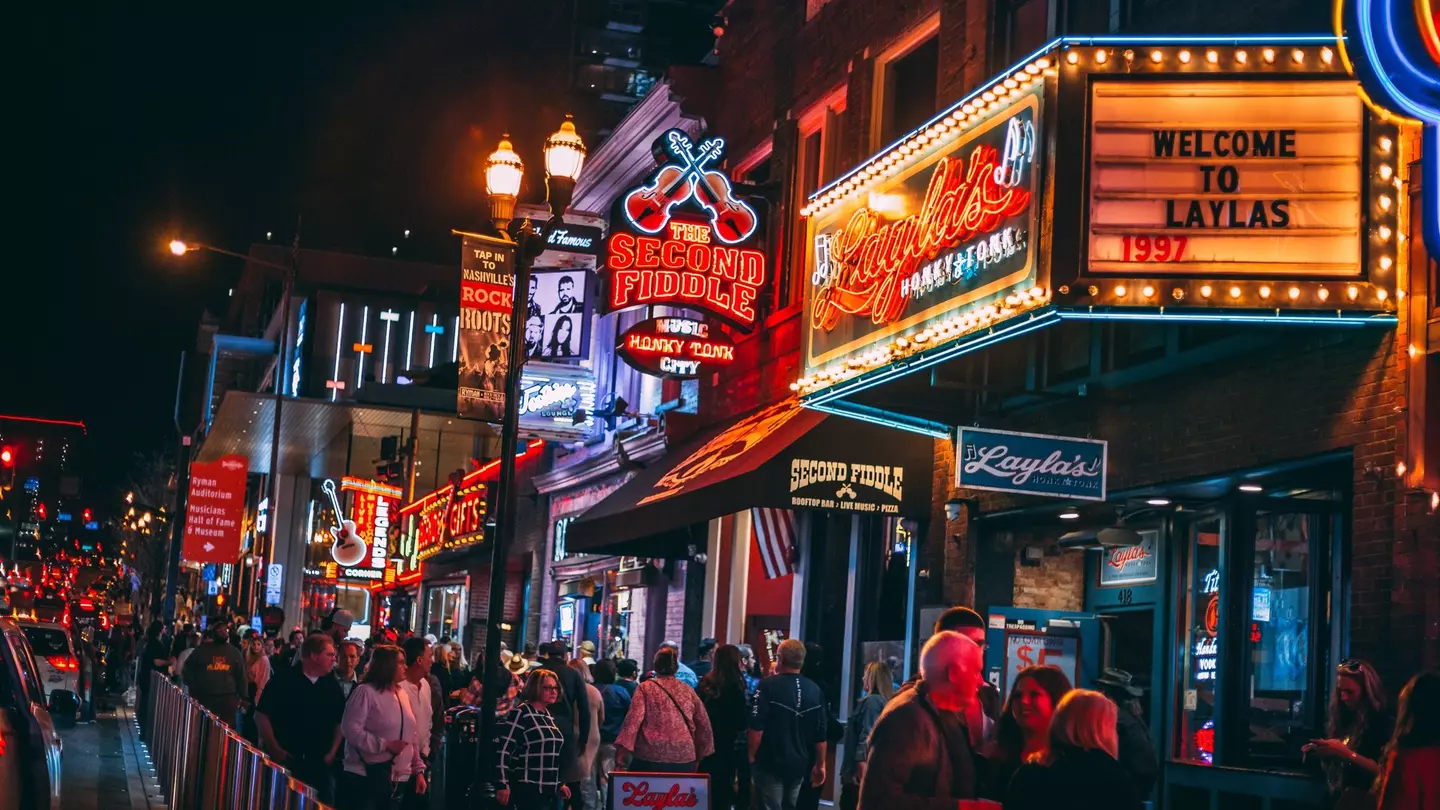 Honky-tonks on Lower Broadway at night with its neon signs. The Country Music District is famous for its entertainment establishments and vibrant nightlife.