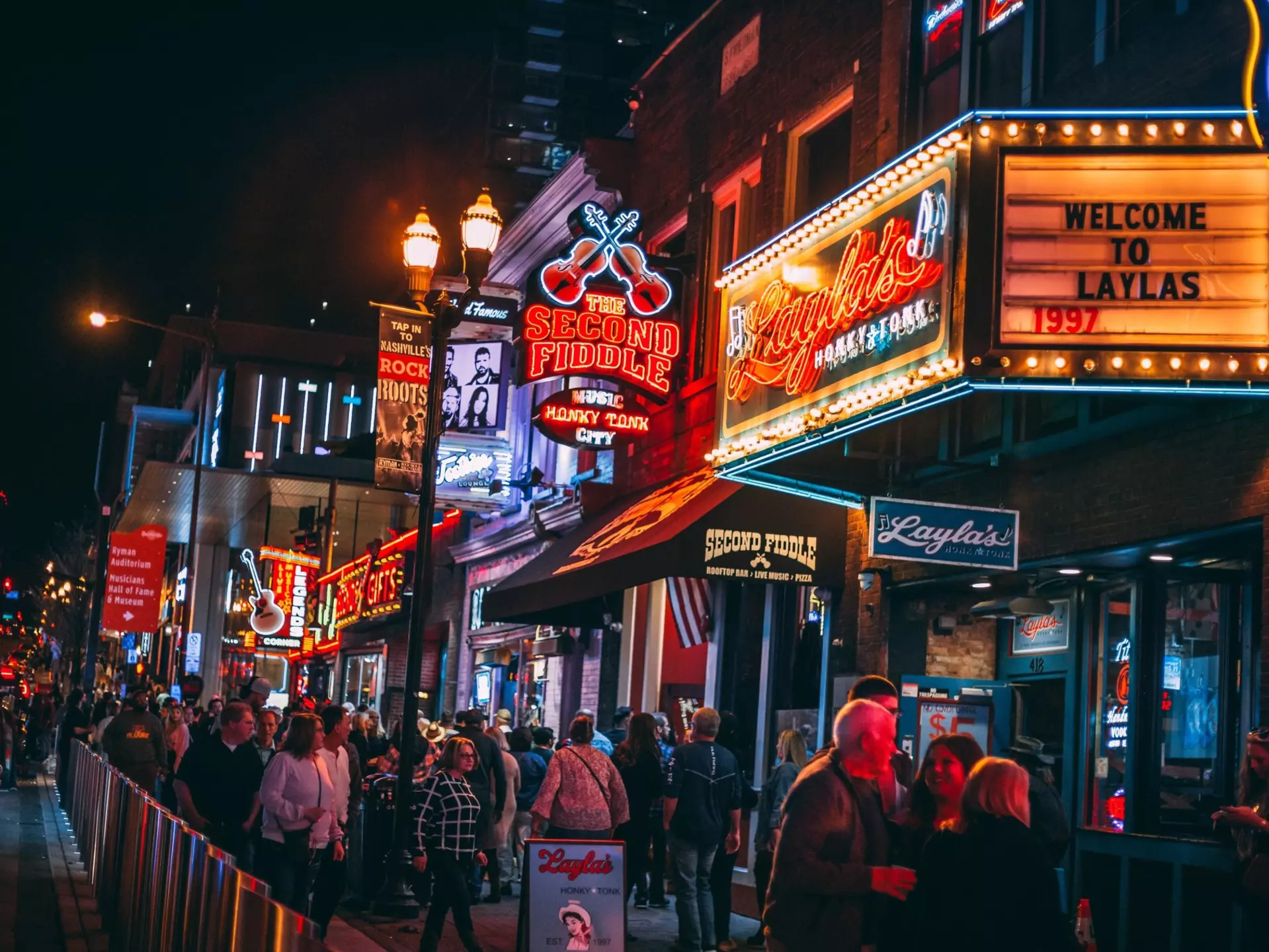 Honky-tonks on Lower Broadway at night with its neon signs. The Country Music District is famous for its entertainment establishments and vibrant nightlife.