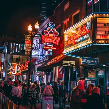 Honky-tonks on Lower Broadway at night with its neon signs. The Country Music District is famous for its entertainment establishments and vibrant nightlife.