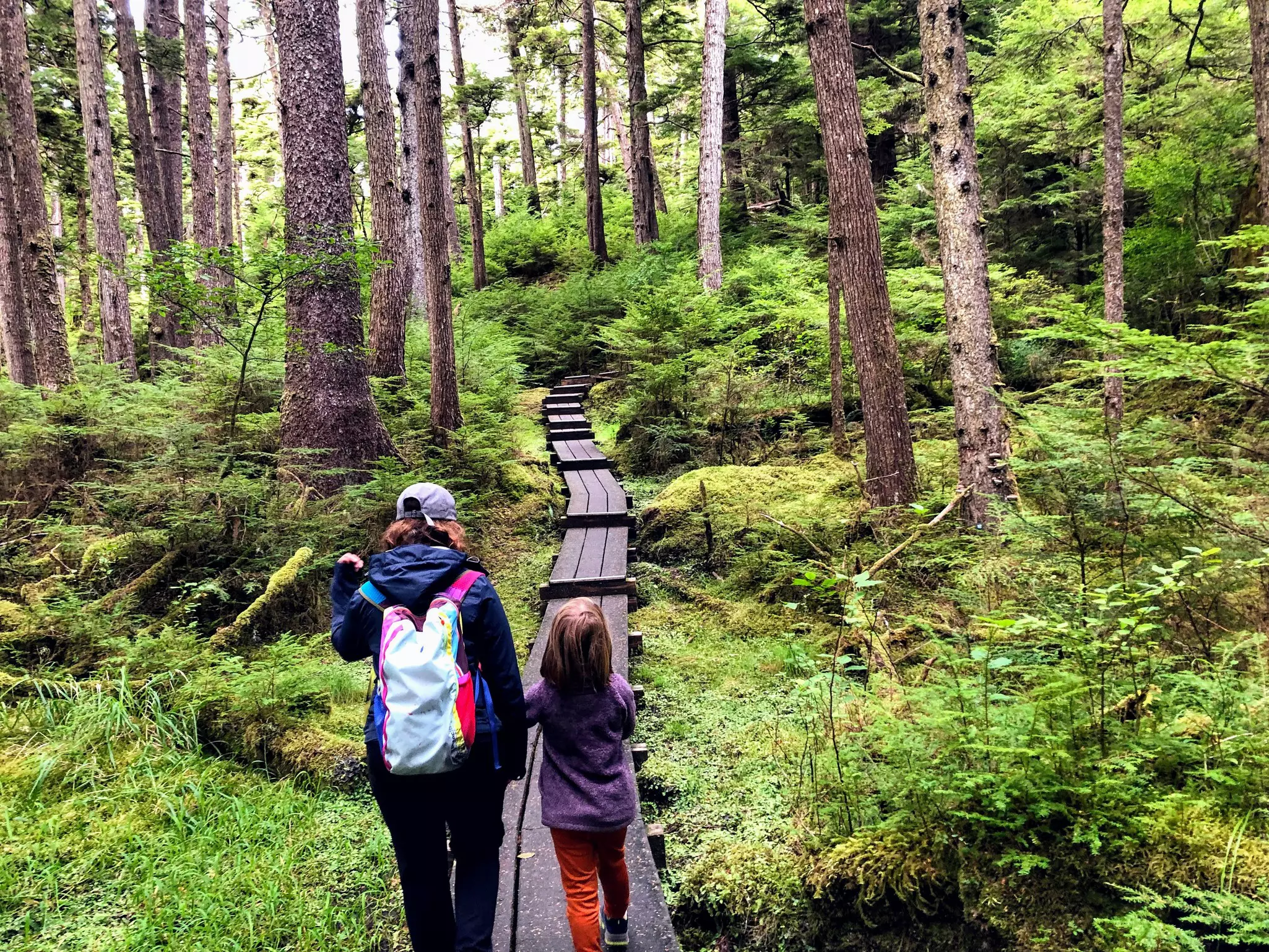 A mother and daughter walking in Naikoon Provincial Park, Haida Gwaii, British Columbia, Canada.