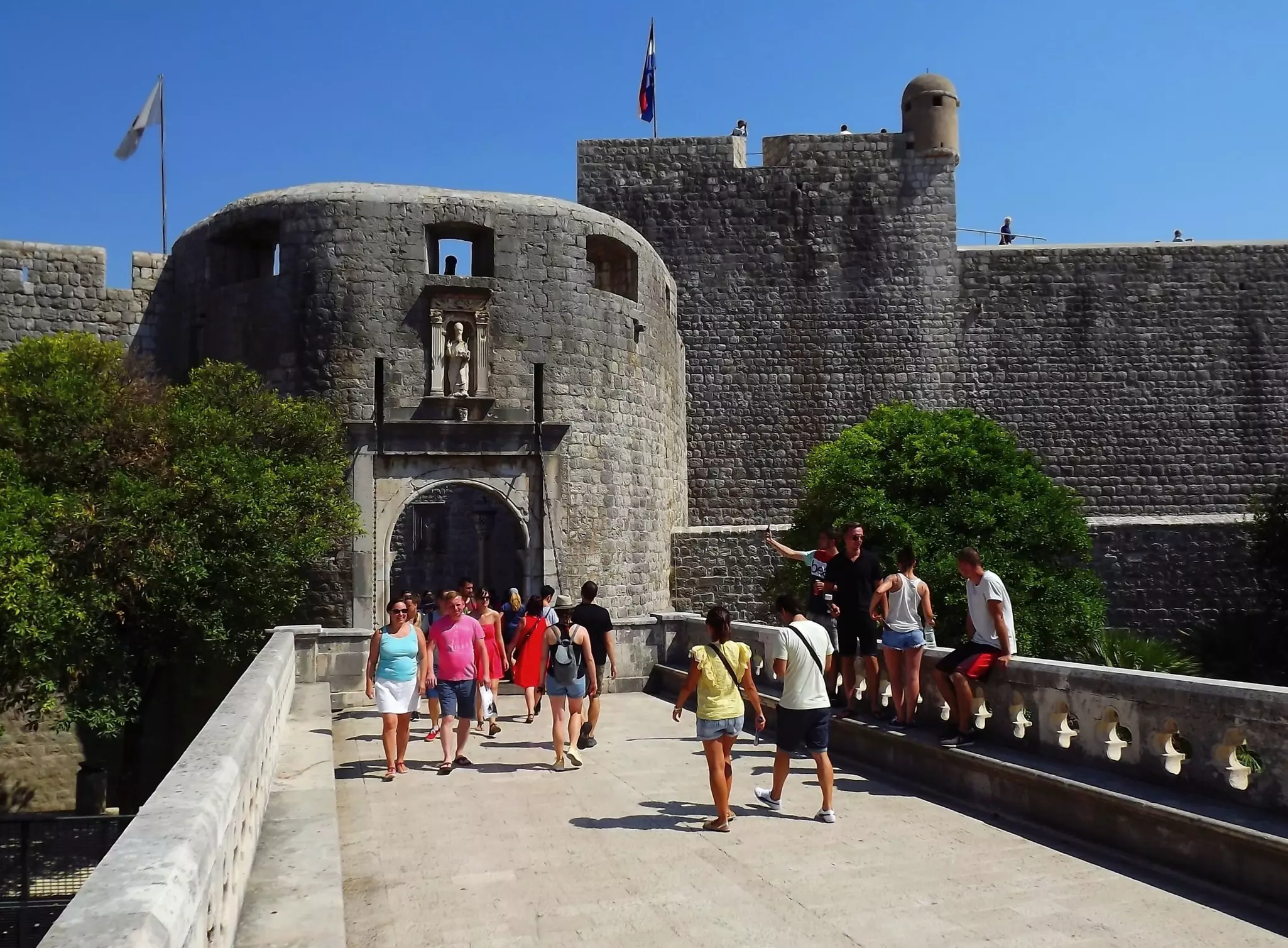 Visitors enter Dubrovnik's city walls via the Pile Gate, Croatia.