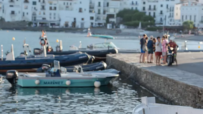 Boats on the beach and the houses of the village of Cadaqués, Spain, in summer