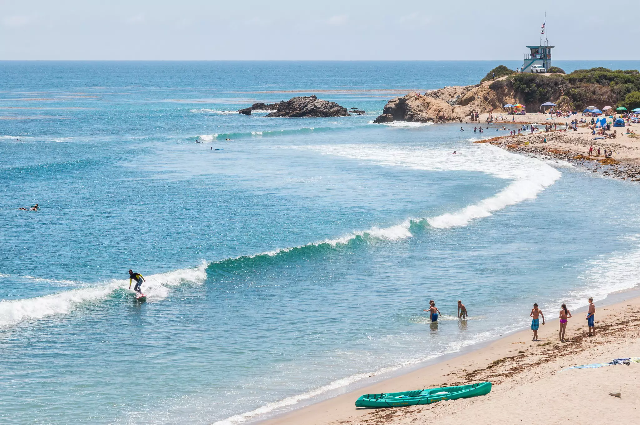 Surfers, swimmers and sunbathers on a summer day in southern California. ©David M. Schrader/Shutterstock