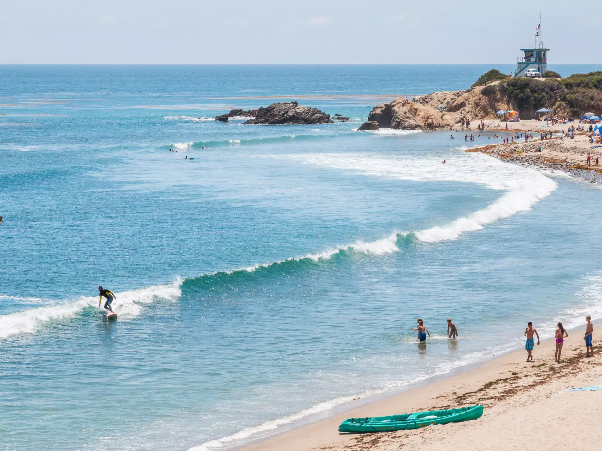 Surfers, swimmers and sunbathers on a summer day in southern California. ©David M. Schrader/Shutterstock