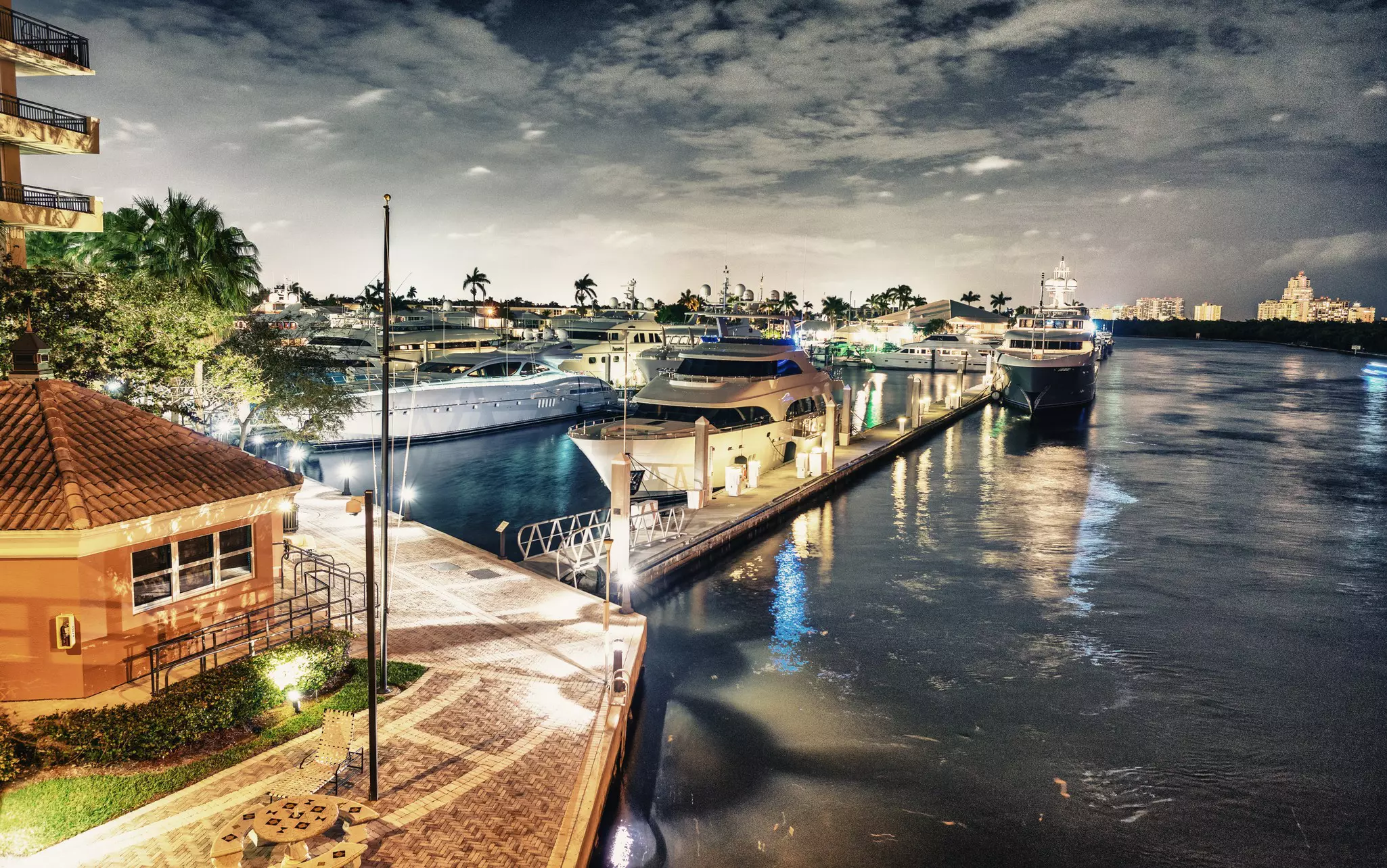 Boats are moored at a pier in an inland canal by evening.