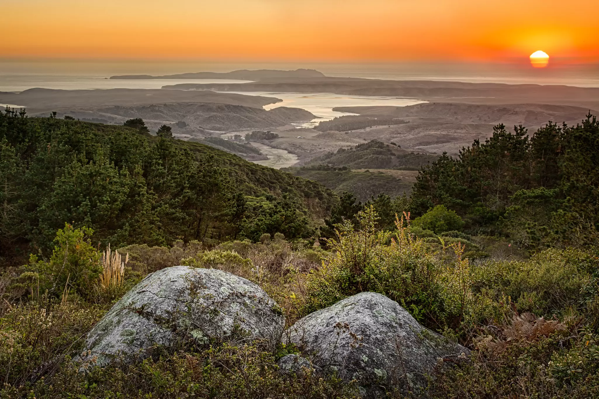 Sunset into the Pacific, rocks/ trees - foreground