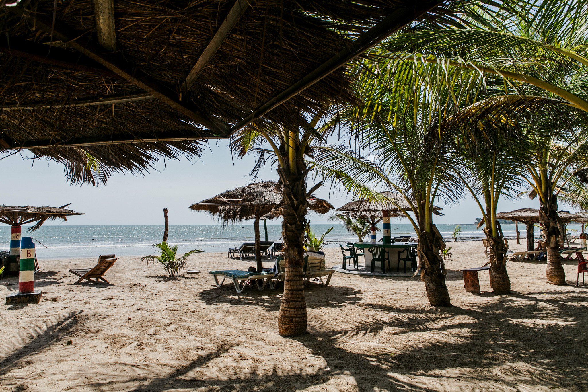 September 2014: Palm trees and wooden umbrellas in the Sanyang area.
1007725986
Sea, Sunlight, Sun, Sunny, Water, Sanyang, West Africa, Tranquility, Idyllic, Tropical Tree, Beach, Outdoors, Atlantic Ocean, Vacations, Kombo, Umbrella, Tropical Climate, Sand, Tree, Summer, Coastline, Landscape - Scenery, No People, Palm Tree, Travel, Gambia, Relaxation, Photography, Color Image, Wood - Material, Africa, Nature, Travel Destinations, Horizontal
