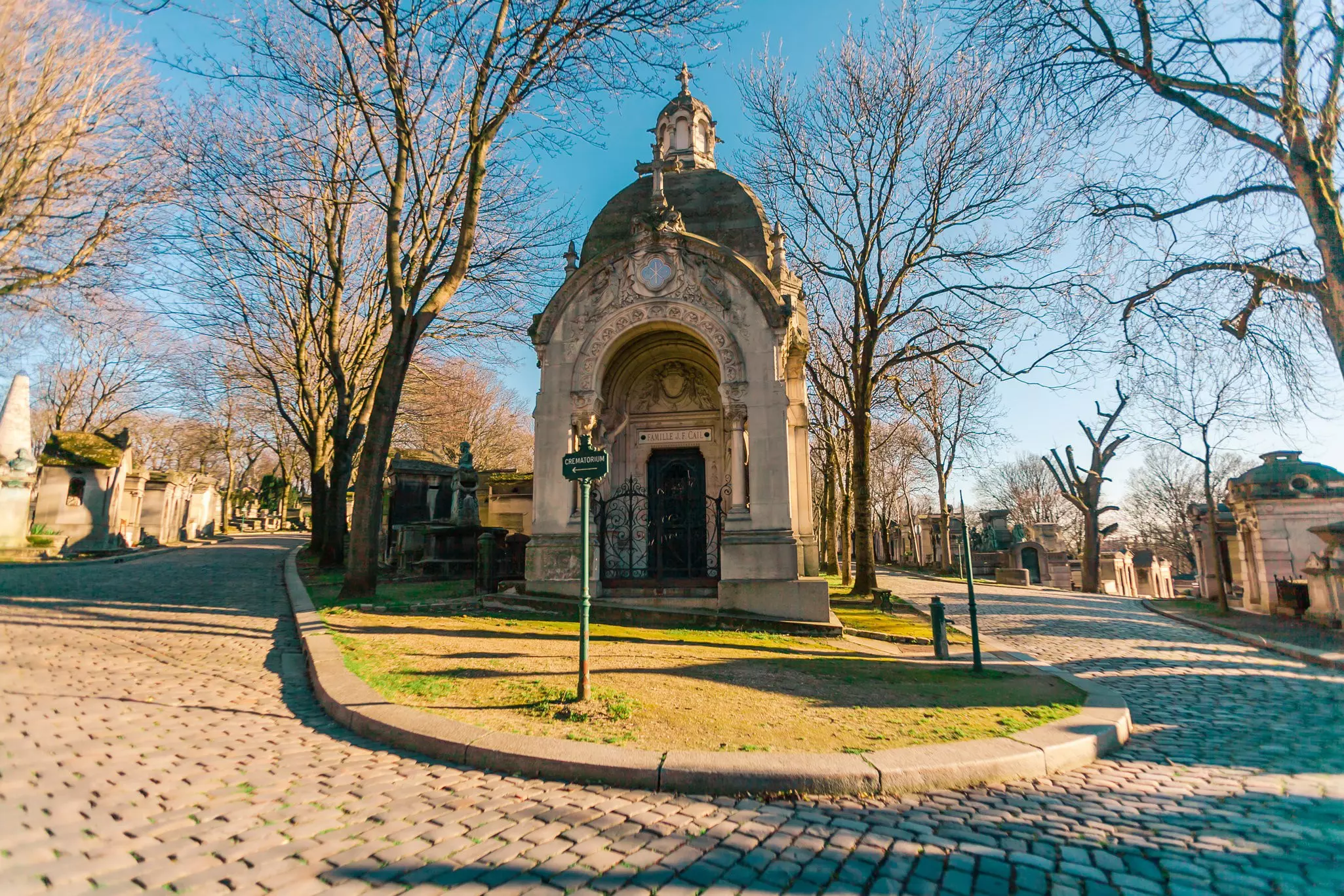 Père Lachaise Cemetery with a crematorium sign and mausoleums.