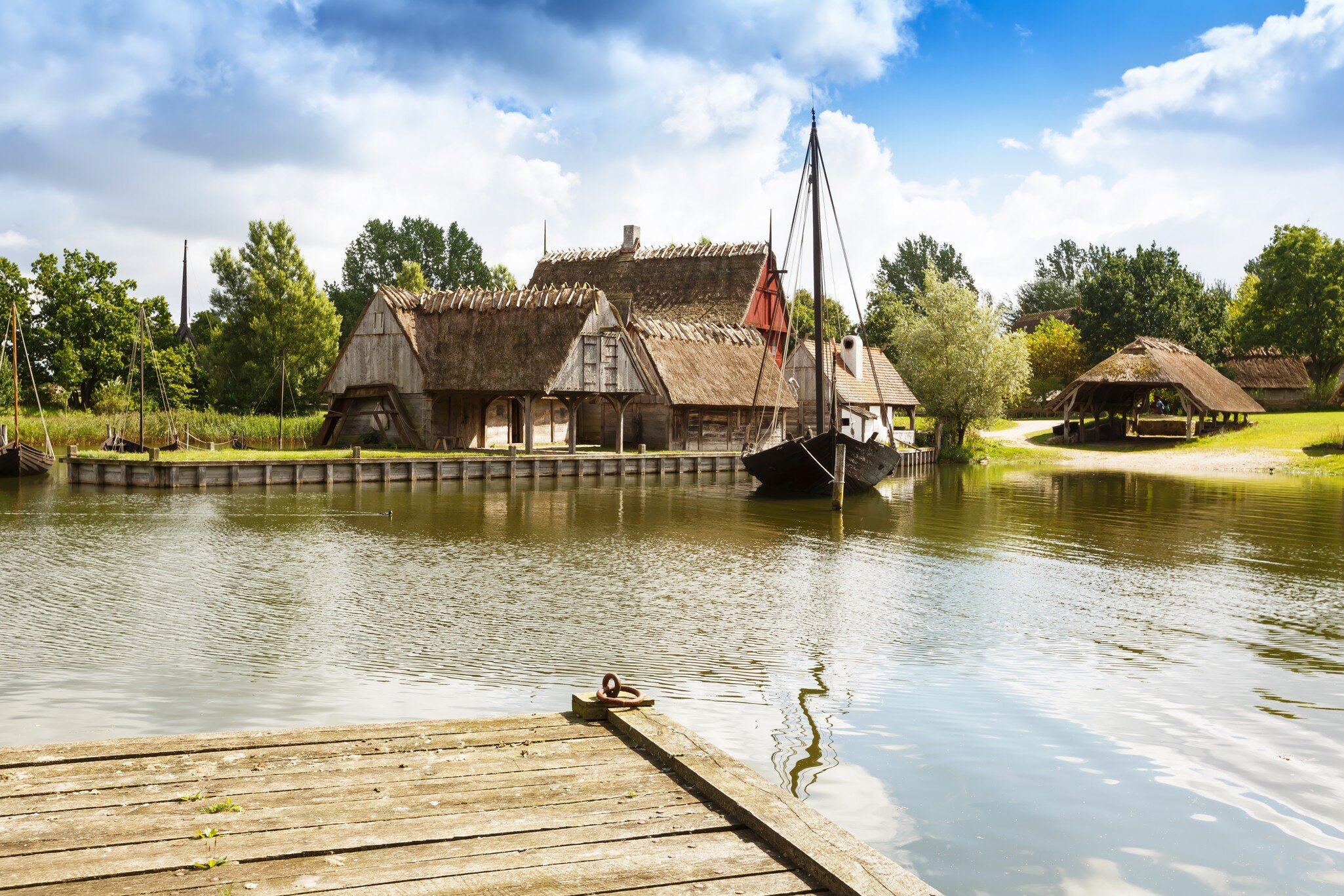 The medieval houses and boats in The Middle Ages Center, the experimental living history museum in Sundby Lolland, Denmark.