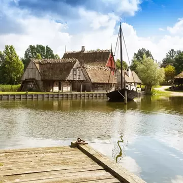 The medieval houses and boats in The Middle Ages Center, the experimental living history museum in Sundby Lolland, Denmark.