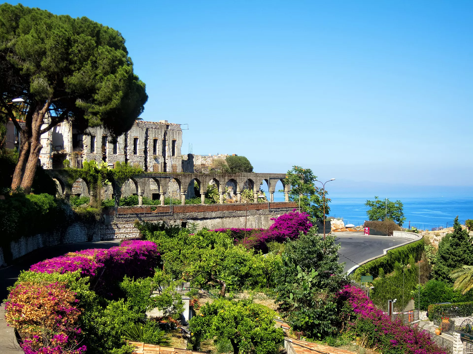 A road trip through Sicily will bring you views of gorgeous towns like Taormina. laraslk/Shutterstock