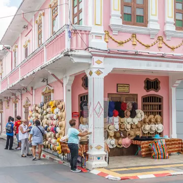 Phuket, Thailand - 2nd September 2018: tourists and hat stall, Thalang Road at junction with Soi Rommanee. Many tourists come to visit., License Type: media, Download Time: 2024-12-13T13:56:14.000Z, User: FergalCo, Editorial: true, purchase_order: 56530 - Guidebooks, job: Global Publishing WIP, client: Pocket Phuket 6, other: Fergal Condon
