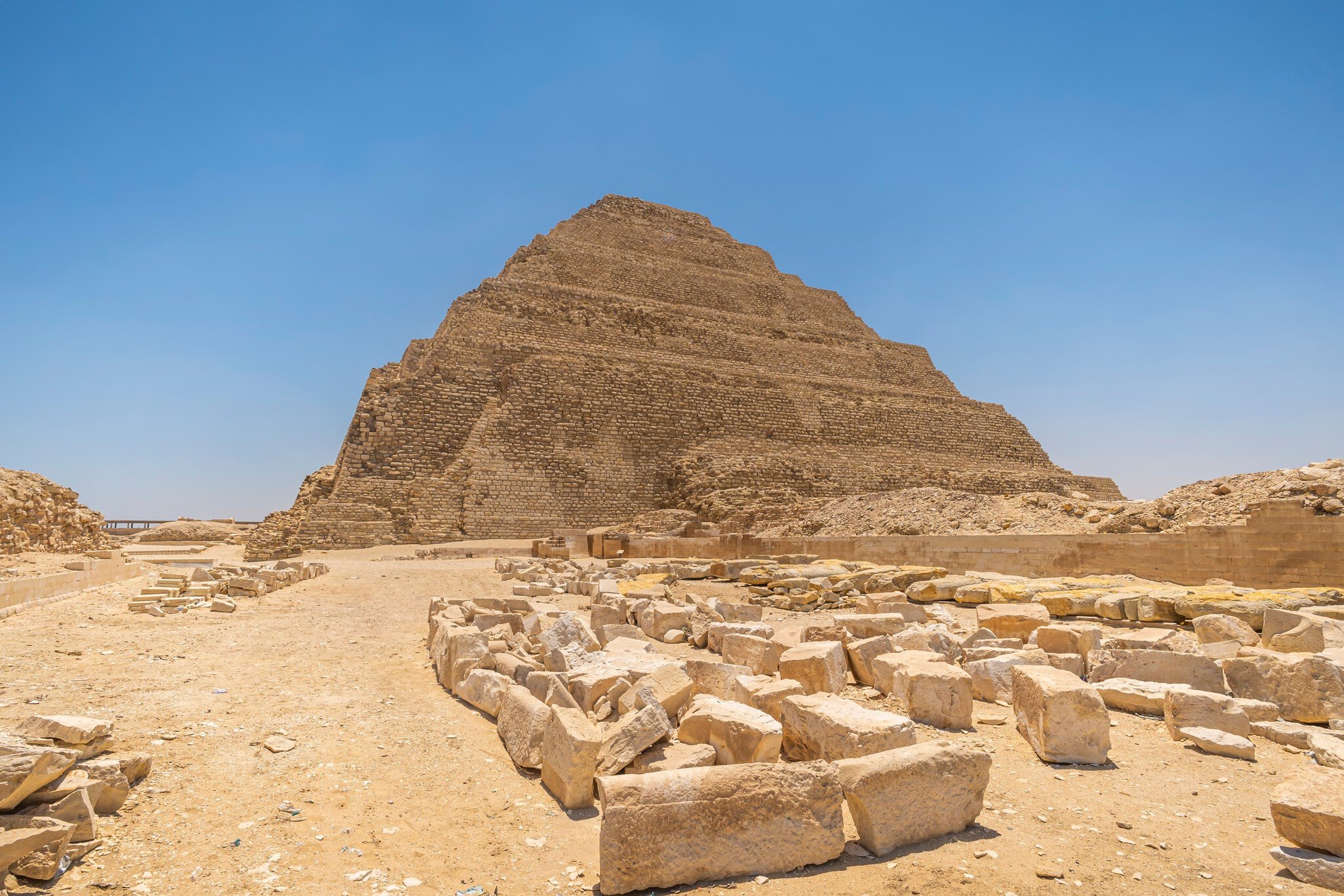 It is the most remarkable construction of the necropolis of Saqqara, south of the city of Memphis. Some tourists walk next to the pyramid..Saqqara, Egypt. March 27, 2008