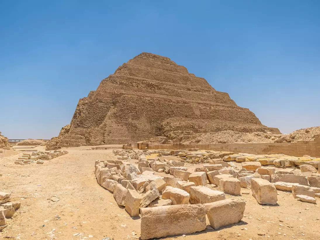 It is the most remarkable construction of the necropolis of Saqqara, south of the city of Memphis. Some tourists walk next to the pyramid..Saqqara, Egypt. March 27, 2008