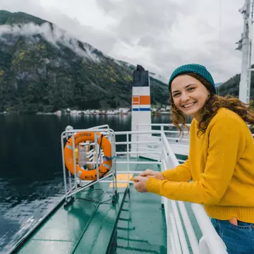 Young Caucasian woman traveling by ferry in Norway
