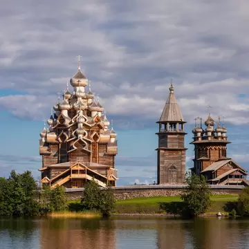 Kizhi, Russia - 13 Aug 2020: 17th-century wooden churches and bell tower of Kizhi Pogost historical site, listed as UNESCO World Heritage Site and one of the most popular tourist destinations in Republic of Karelia
