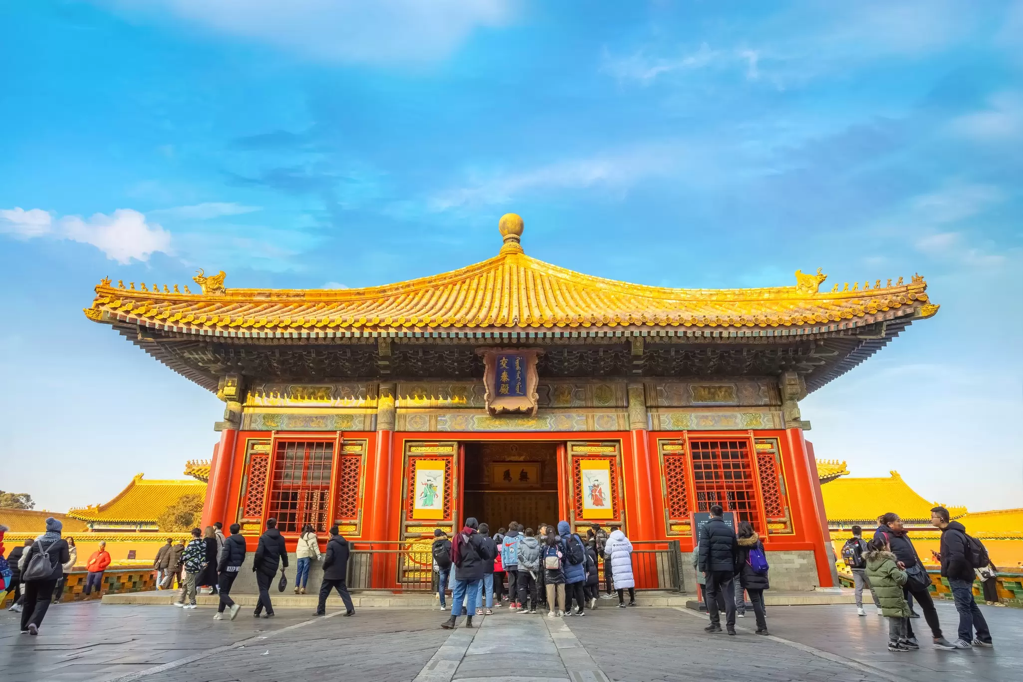 People stand in front of a palace in Beijing's Forbidden City. 