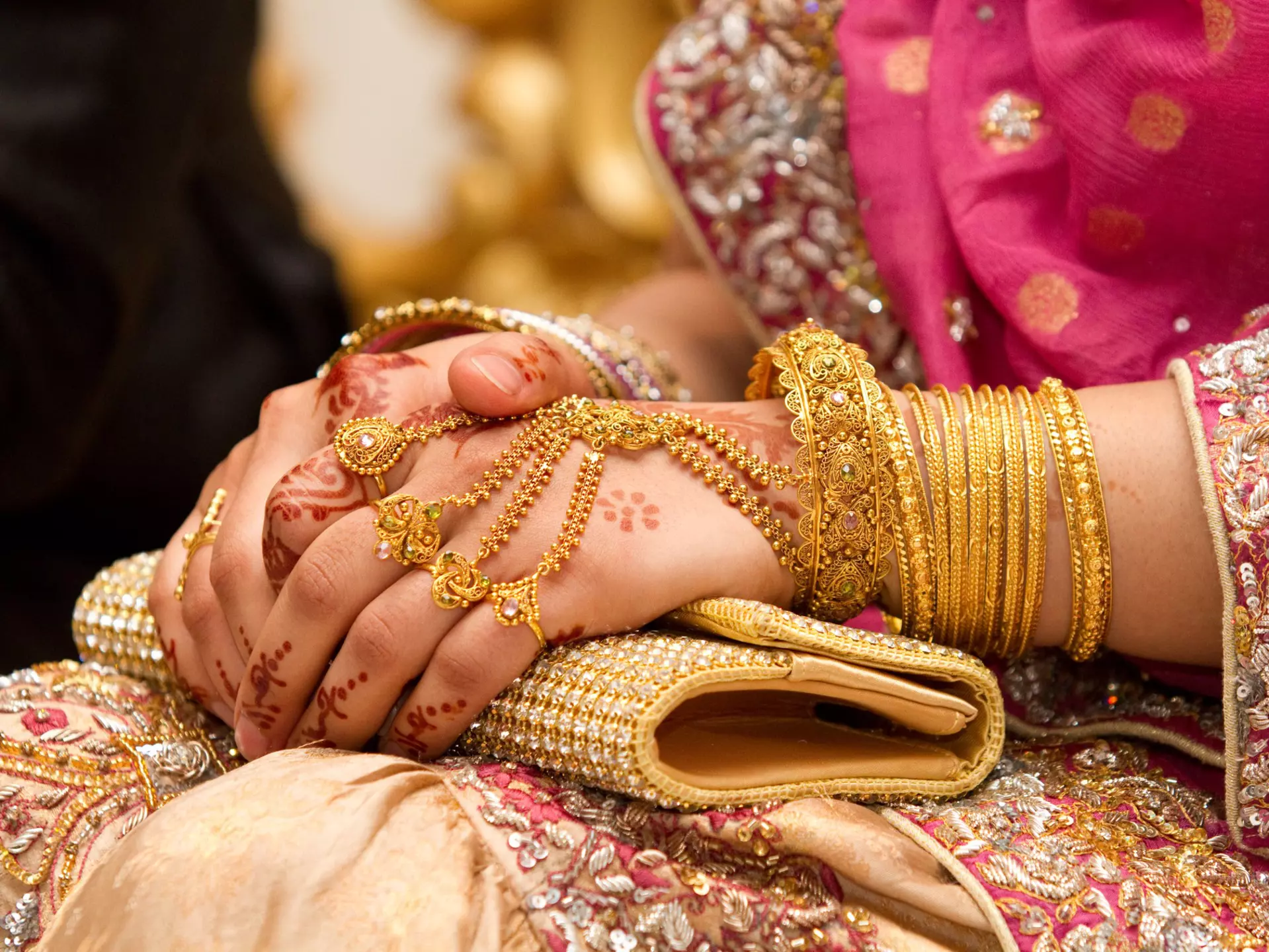 Muslim brides hands decorated with henna and gold jewellery.
143999506