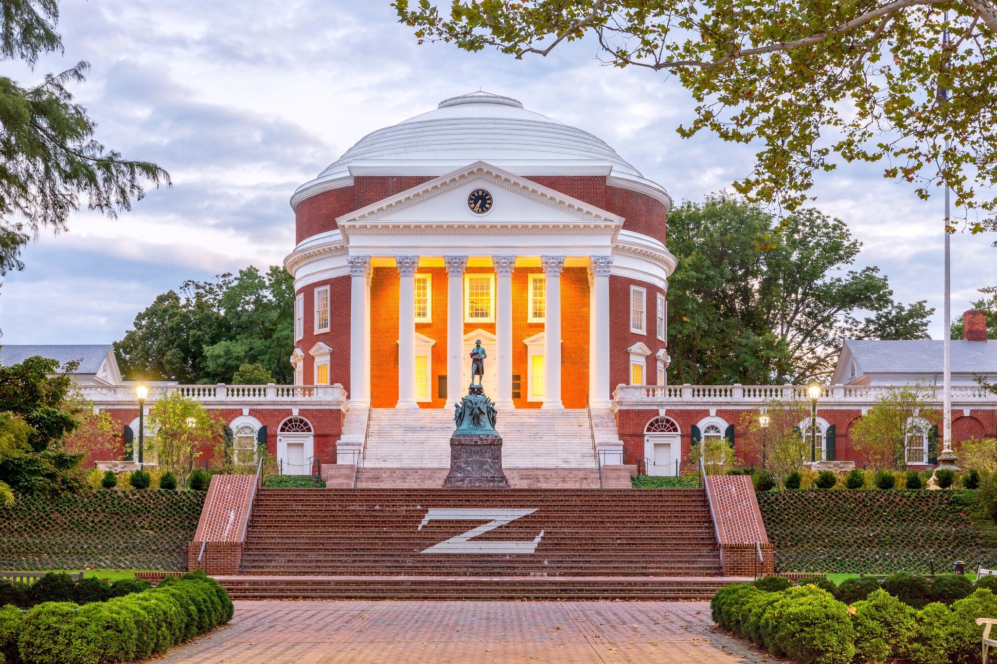 September 16, 2017: The Rotunda at the University of Virginia at dusk with the Thomas Jefferson Statue in the foreground.