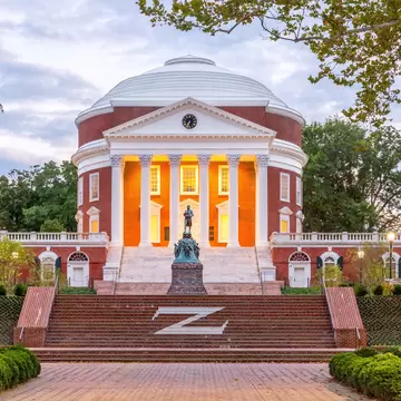 September 16, 2017: The Rotunda at the University of Virginia at dusk with the Thomas Jefferson Statue in the foreground.