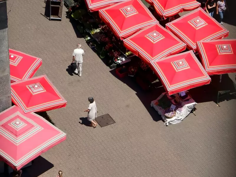 Aerial view of Dolac Market in Zagreb as visitors walk among the red canopies of the market stalls