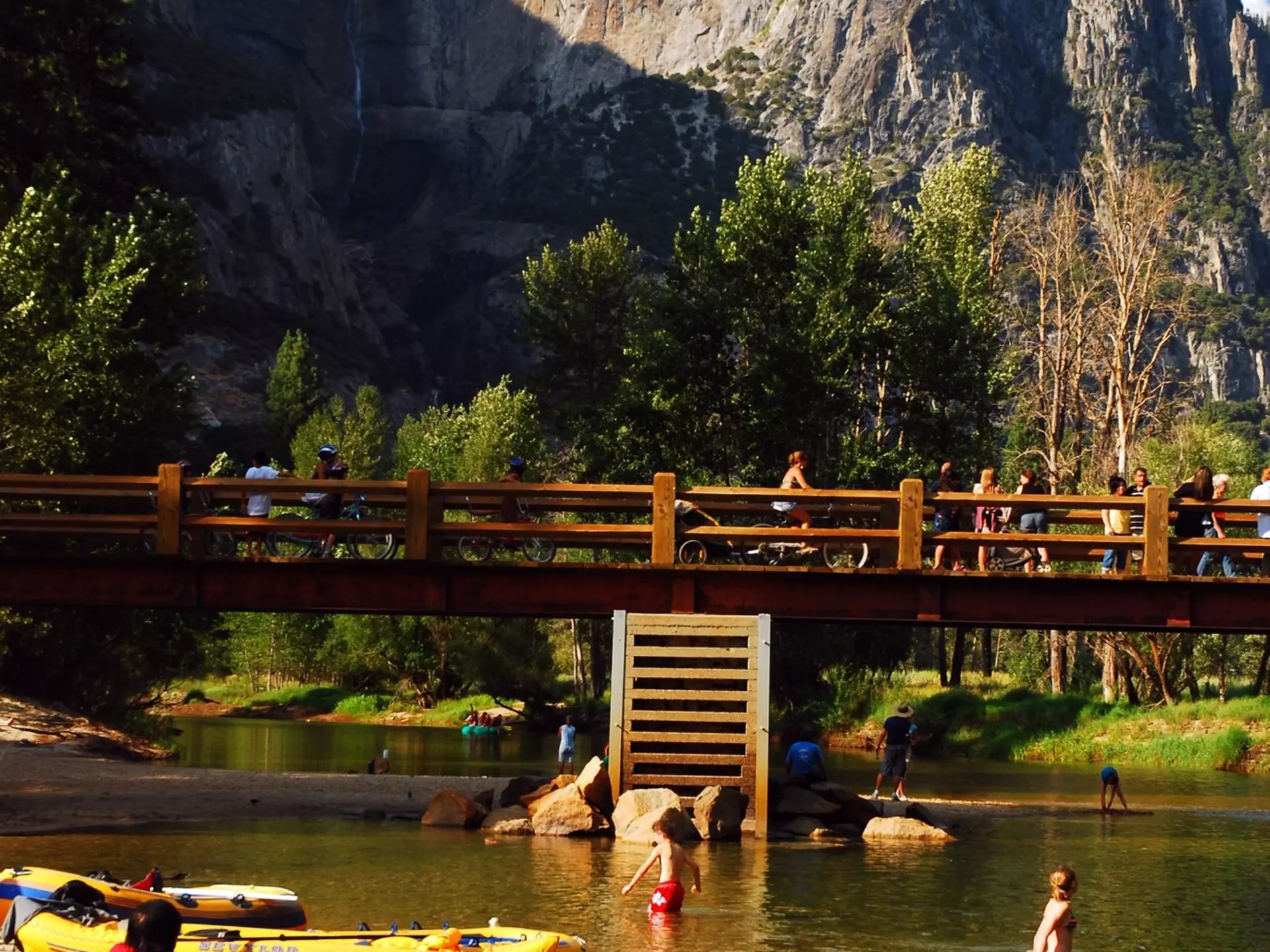Inflatable rafts are brought to the shore, allowing people to wade in the Merced River in Yosemite National Park, California. 